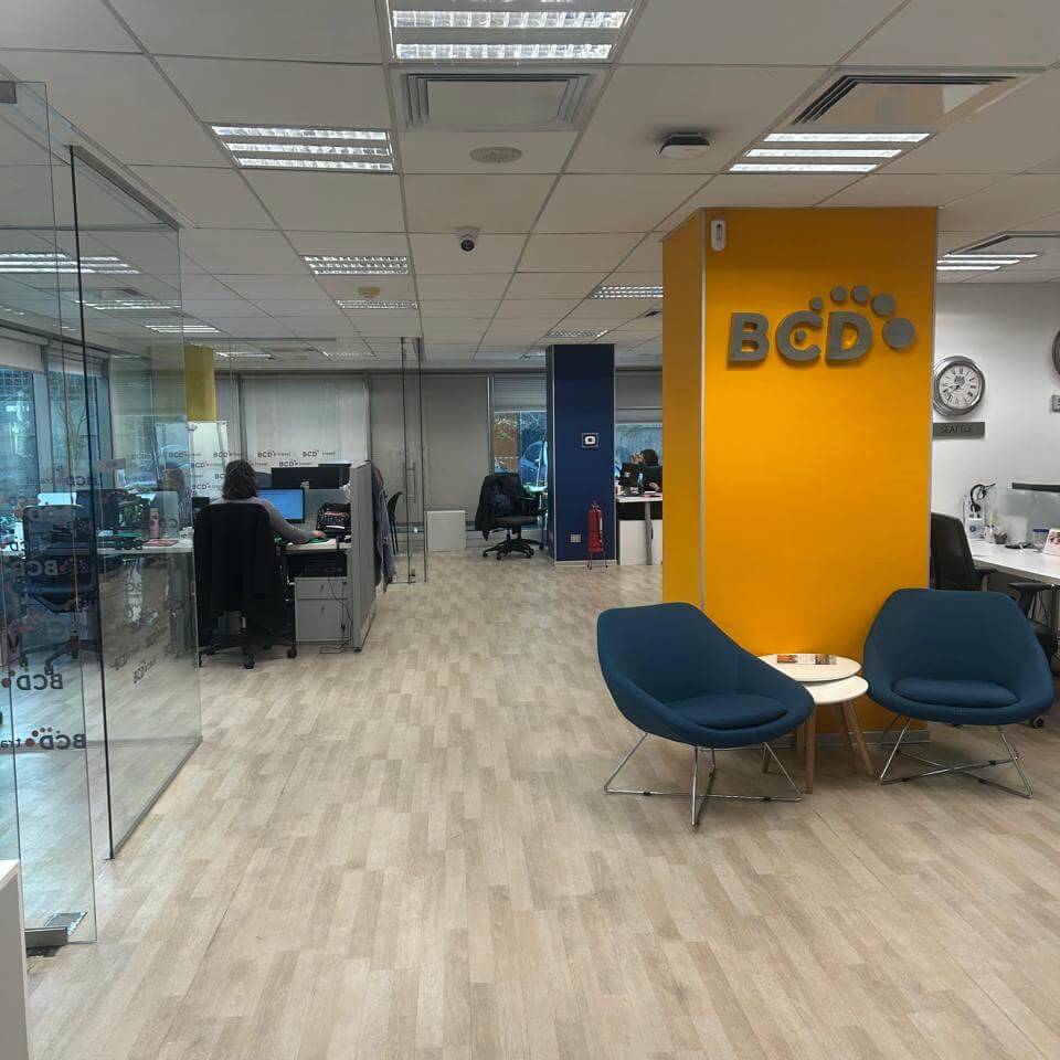 Modern office interior with workstations and seating area.