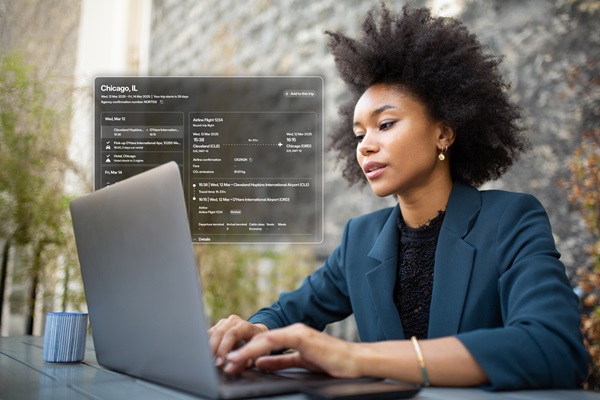 Woman working on laptop with city info overlay.