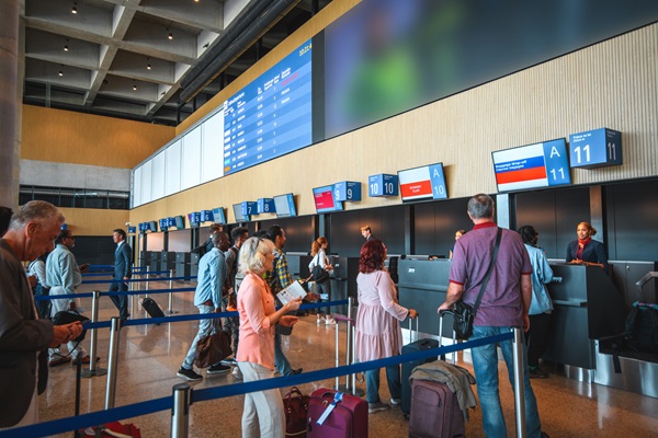 People checking in at airport counter.