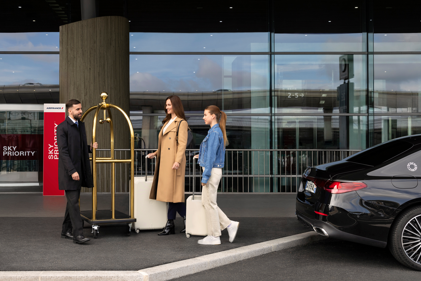 Travelers with luggage at airport pickup zone