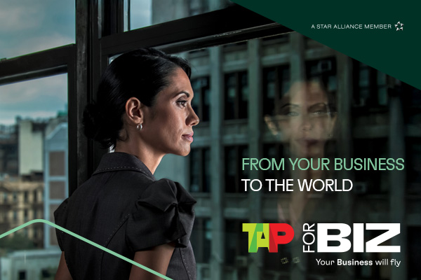 Businesswoman looking out window, text: From Business to World.