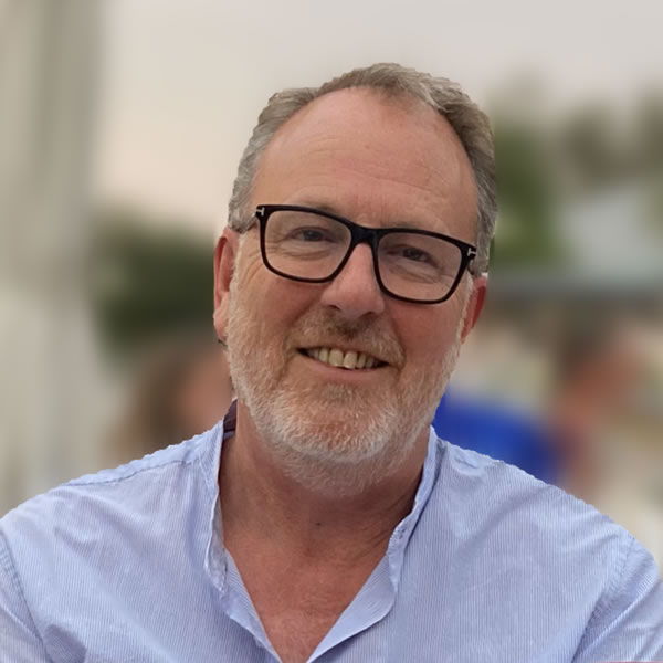 Smiling man with glasses outdoors